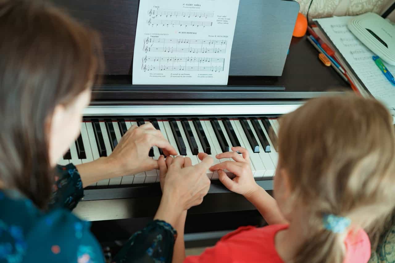 Piano teacher with student